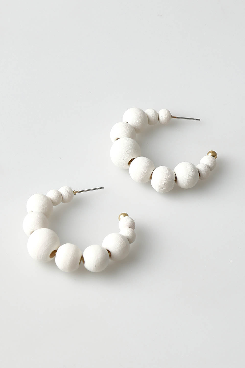 A model wearing the Senorita Earring in colour White (White), from the front, showing the whole outfit