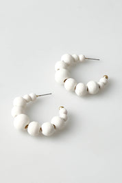 A model wearing the Senorita Earring in colour White (White), from the front, showing the whole outfit
