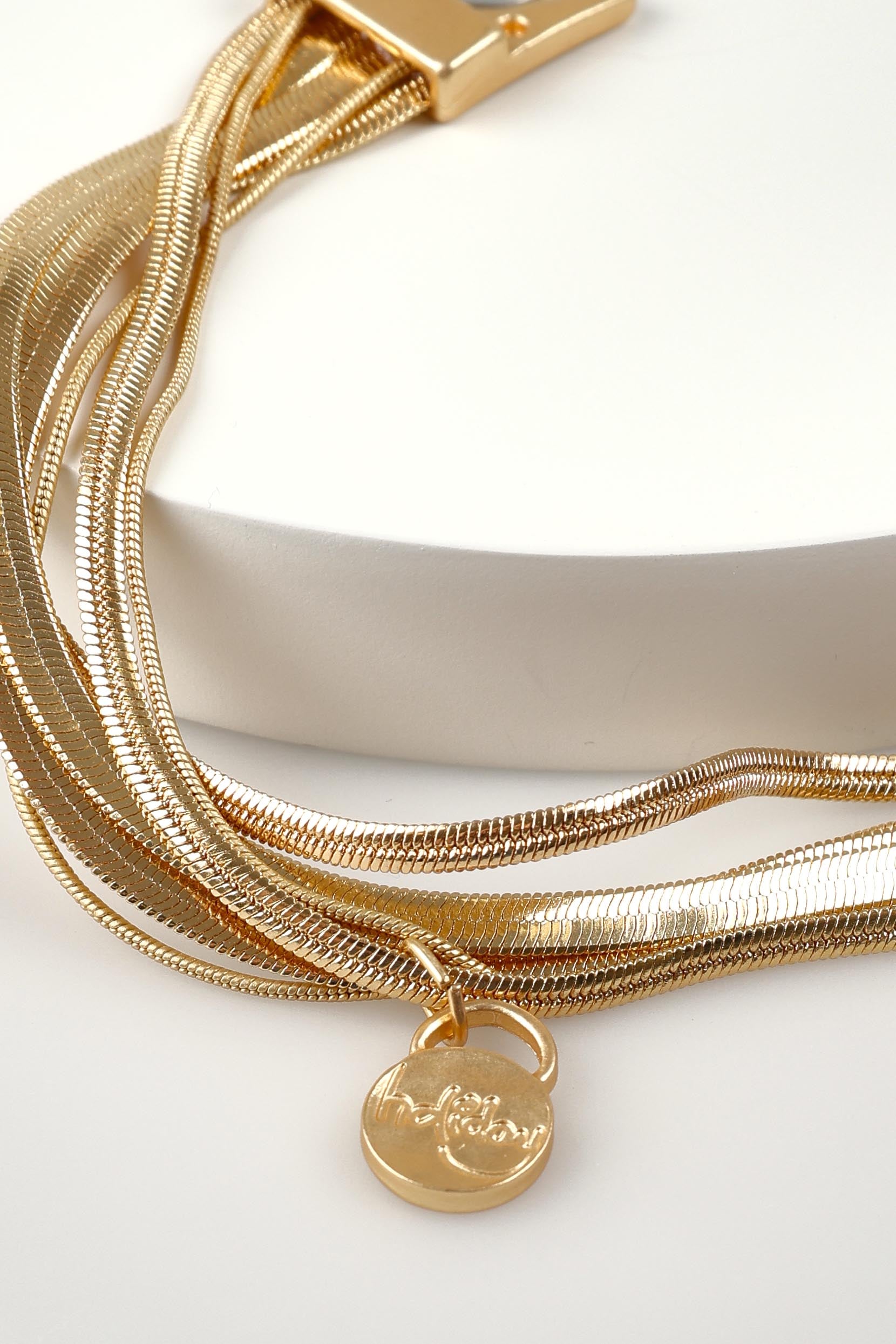 A model wearing the Digby Bracelet in colour Gold (Metallics), from the front, showing the whole outfit