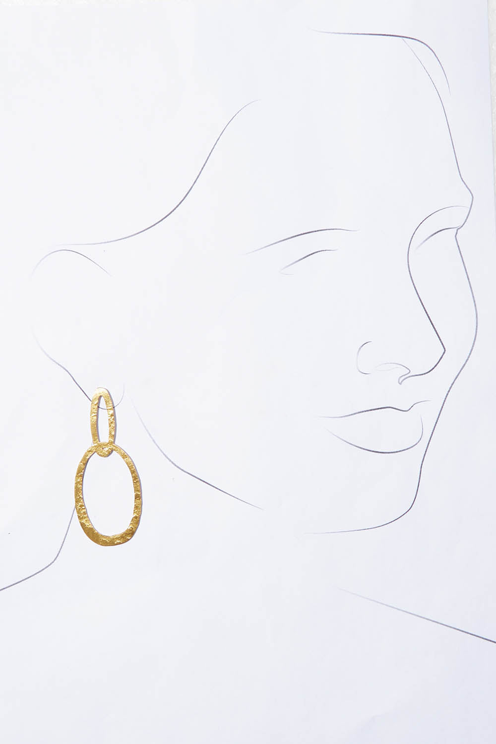 A model wearing the Pegasus Earrings in colour Gold (Metallics), from the front, showing the whole outfit