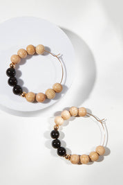 A model wearing size OneSize of the Shadow Stone Hoop Earrings in colour Black (Black), from the front, showing the whole outfit