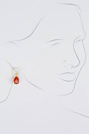 A model wearing size OneSize of the Carrie Earrings in colour Ruby (Red), from the front, showing the whole outfit