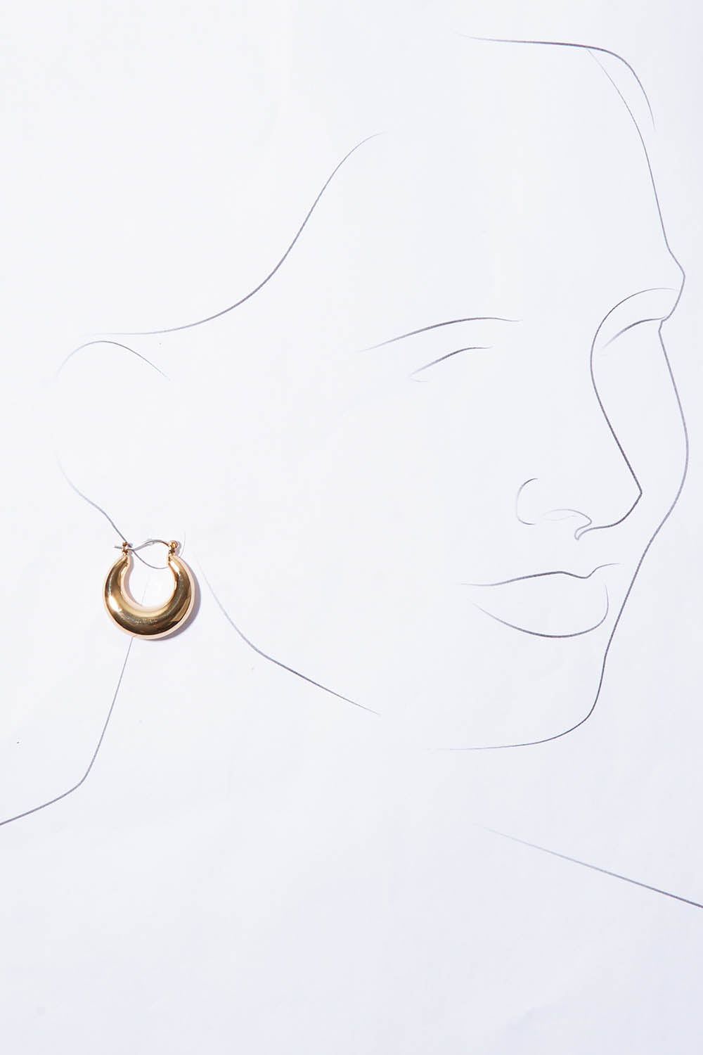 A model wearing the Fergie Earrings Small in colour Gold (Metallics), from the front, showing the whole outfit