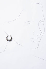 A model wearing the Fergie Earrings Small in colour Silver (Metallics), from the front, showing the whole outfit
