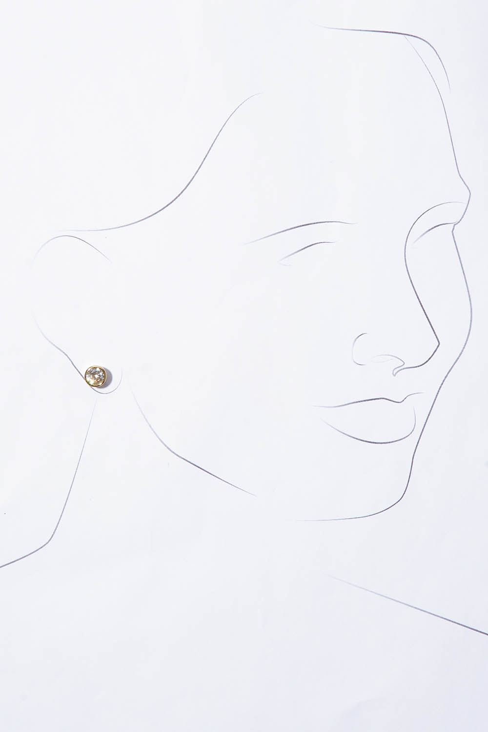 A model wearing the Madga Earrings in colour Gold (Metallics), from the front, showing the whole outfit