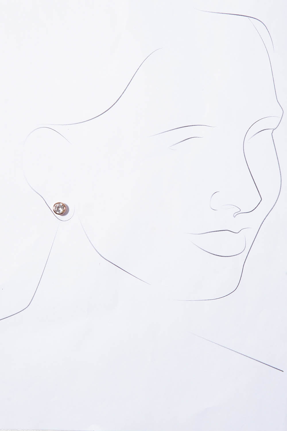 A model wearing the Madga Earrings in colour Rosegold (Metallics), from the front, showing the whole outfit