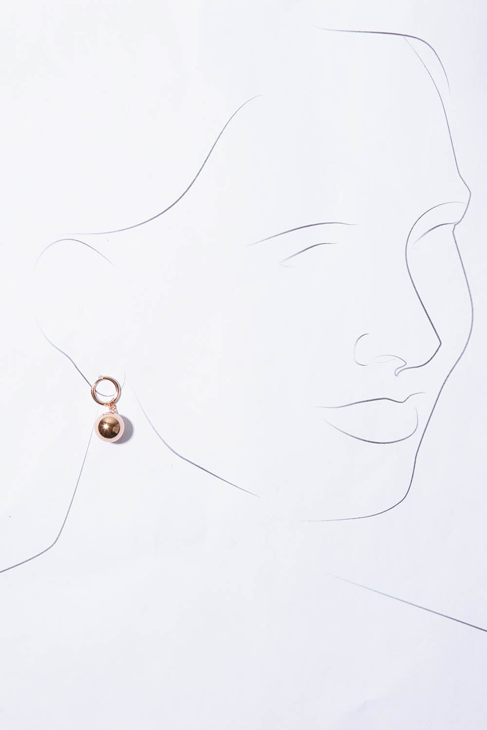 A model wearing the Mentone Earrings in colour Rosegold (Metallics), from the front, showing the whole outfit