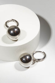 A model wearing size OneSize of the Mentone Earrings in colour Silver (Metallics), from the front, showing the whole outfit