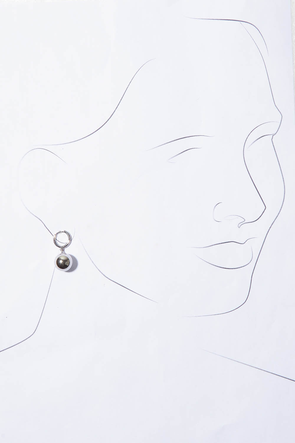A model wearing the Mentone Earrings in colour Silver (Metallics), from the front, showing the whole outfit