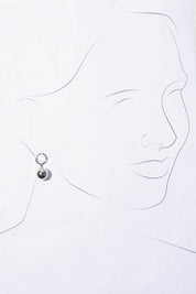 A model wearing the Mentone Earrings in colour Silver (Metallics), from the front, showing the whole outfit