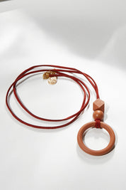 A model wearing size OneSize of the Salsa Necklace in colour Pecan, from the front, showing the whole outfit