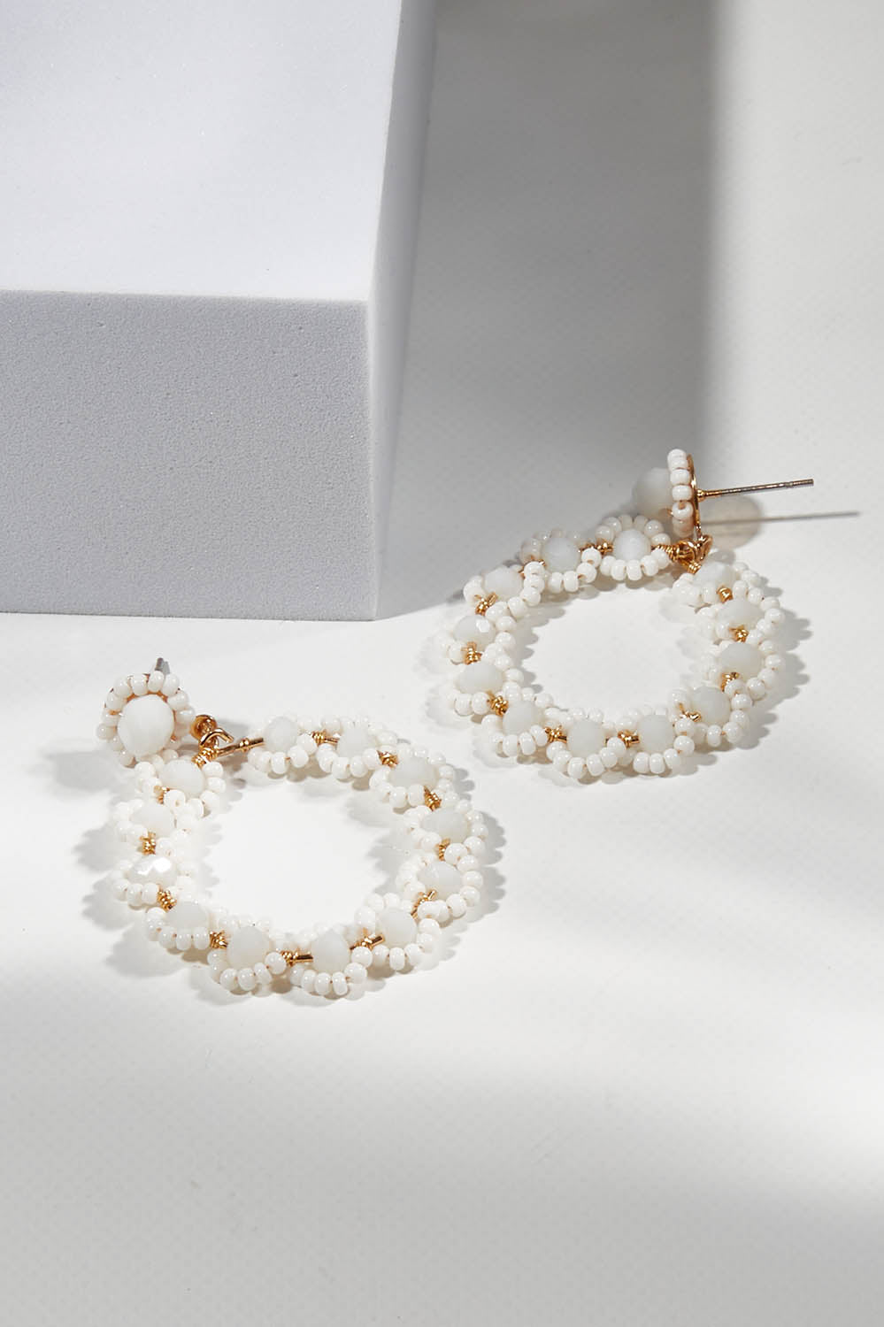 A model wearing size OneSize of the Honey Earrings in colour White (White), from the front, showing the whole outfit