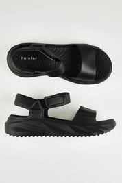 A model wearing size 6 of the Cloud Nine Eva Sandal in colour Black (Black), from the front, showing the whole outfit