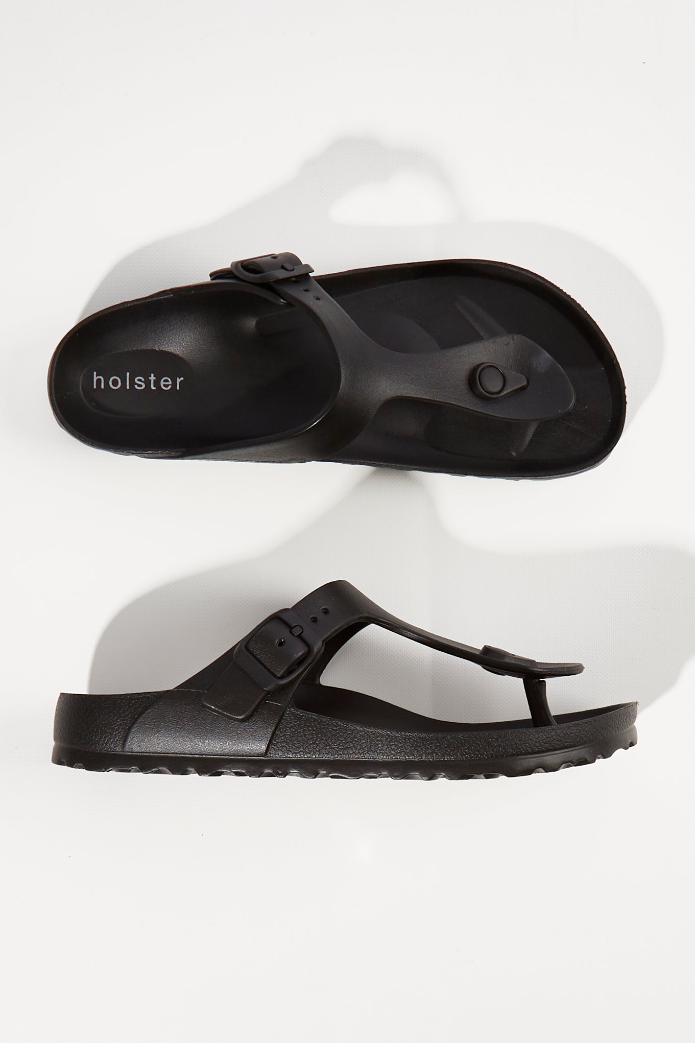 A model wearing size 6 of the Coastal EVA Slide in colour Black (Black), from the front, showing the whole outfit