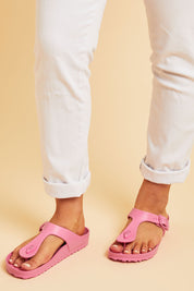 A model wearing size 7 of the Coastal EVA Slide in colour Hotpink (Pink), from the front, cropped image