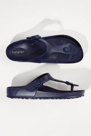 A model wearing size 6 of the Coastal EVA Slide in colour Navy (Blue), from the front, showing the whole outfit