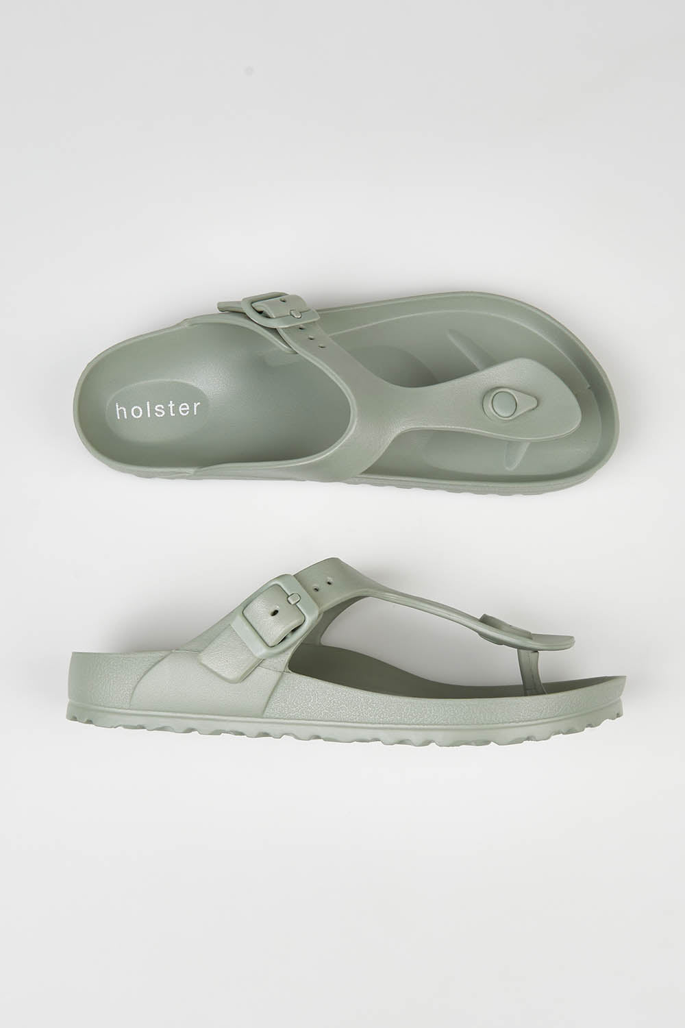 A model wearing size 7 of the Coastal EVA Slide in colour Seagrass (Green), from the front, showing the whole outfit