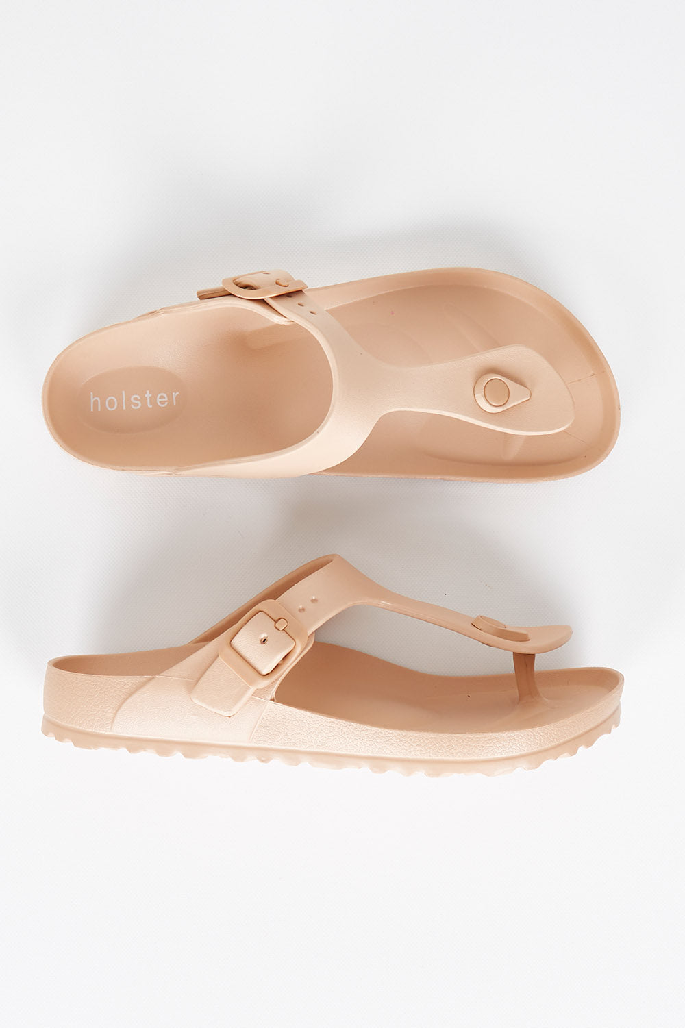 A model wearing size 7 of the Coastal EVA Slide in colour Tan, from the front, showing the whole outfit
