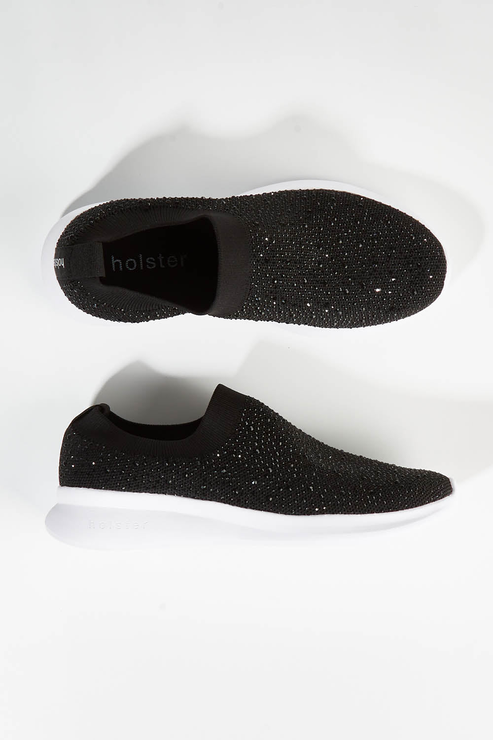 A model wearing size 7 of the Firefly Sneaker in colour Black (Black), from the front, showing the whole outfit