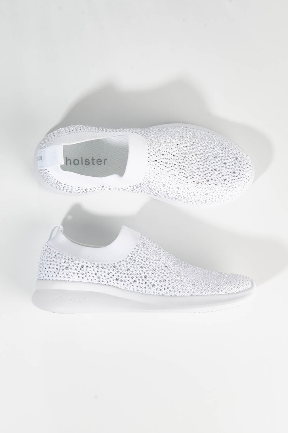A model wearing size 7 of the Firefly Sneaker in colour White (White), from the front, showing the whole outfit