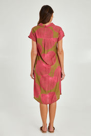 Model Madeline wearing size 10 of the Calforniai Dress in colour Fantasia (Green), from the back