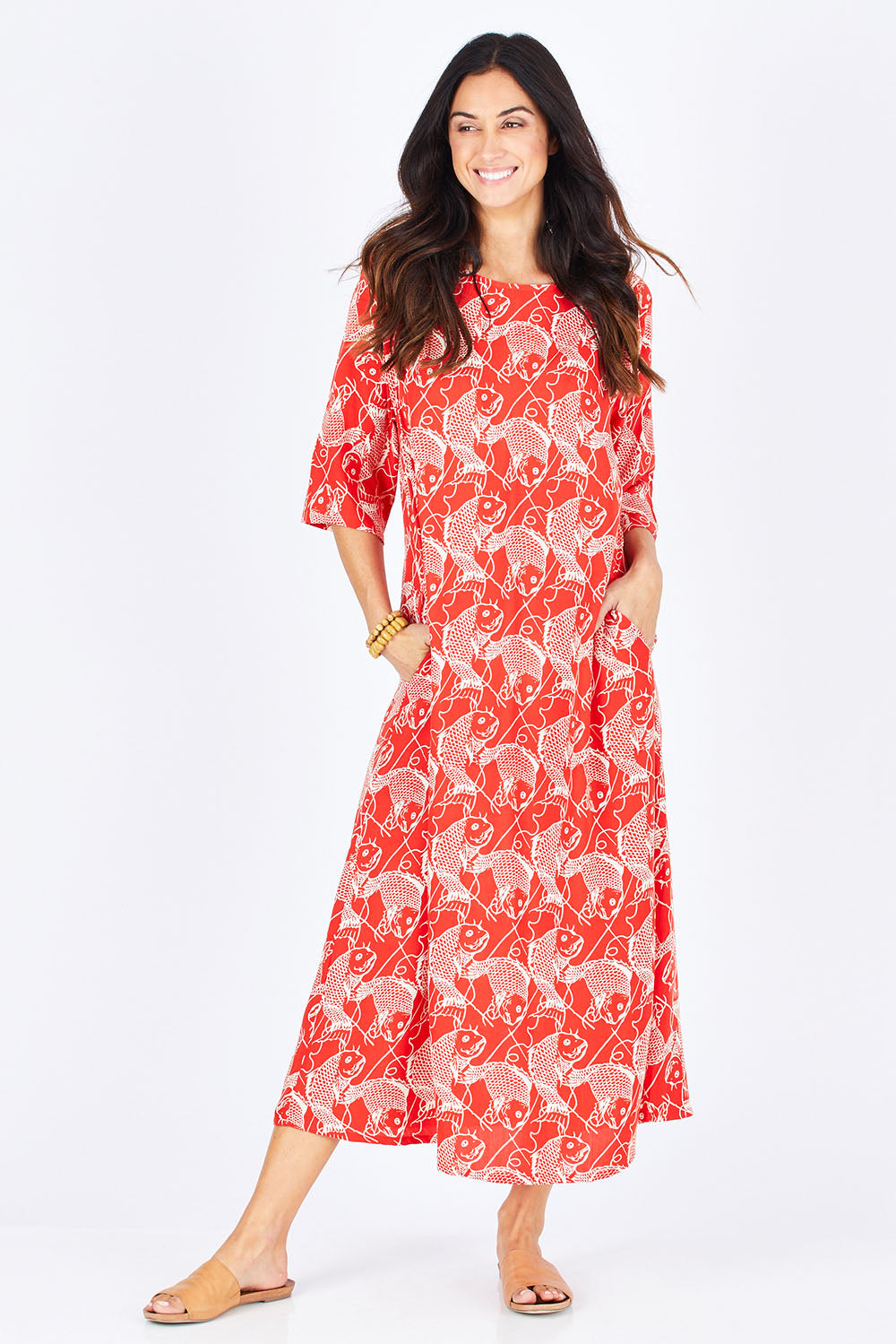 Model Gemma wearing size S of the Carabou Dress in colour NemoRed (Red), from the front, showing the whole outfit