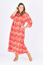 Model Natalia wearing size L of the Carabou Dress in colour NemoRed (Red), from the front, showing the whole outfit