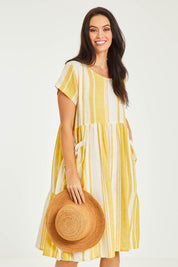 Model Stacey wearing size 10 of the Aireys Dress in colour Lemondrop, from the front, cropped image
