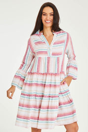 Model Stacey wearing size 10 of the Otway Dress in colour Candystrip (Pink), from the front, cropped image
