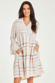 Model Stacey wearing size 10 of the Otway Dress in colour Coralstrip (Blue), from the front, cropped image