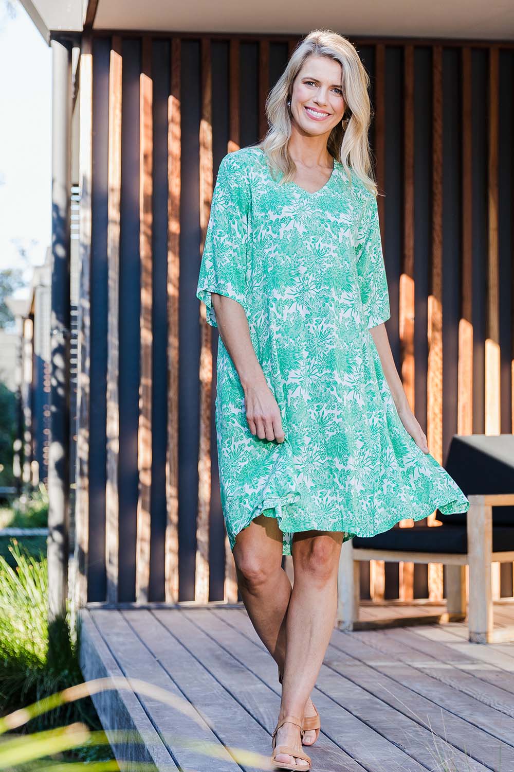 Model Kelly wearing size 10 of the Romance Dress in colour Giardgreen (Green), from the front, showing the whole outfit