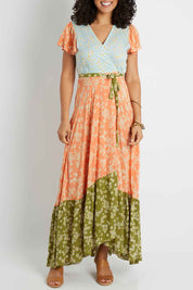 Model Pamela wearing size S of the Margarita Dress in colour Sprinmulti, from the front, cropped image