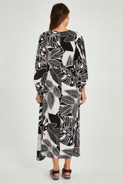 Model Madeline wearing size 10 of the Mimosa Dress in colour Brazil (Black), from the back