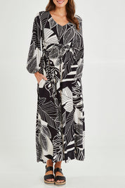 Model Madeline wearing size 10 of the Mimosa Dress in colour Brazil (Black), from the front, cropped image
