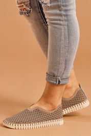 A model wearing size 38 of the Tulip Sneaker in colour Grey (Grey), from the front, cropped image