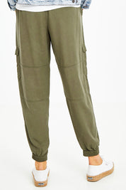 Model Naomi wearing size 10 of the Cecily Cargo Joggers in colour Khaki (Green), from the back