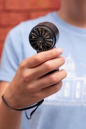 A model wearing the Rechargeable Mighty Mini Fan in colour Black (Black), from the front, showing the whole outfit