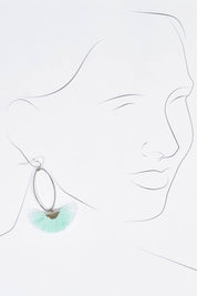 A model wearing size OneSize of the Silver Caprioska Tassel Earrings in colour Mint (Green), from the front, showing the whole outfit