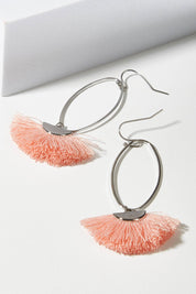 A model wearing size OneSize of the Silver Caprioska Tassel Earrings in colour Peach (Pink), from the front, showing the whole outfit