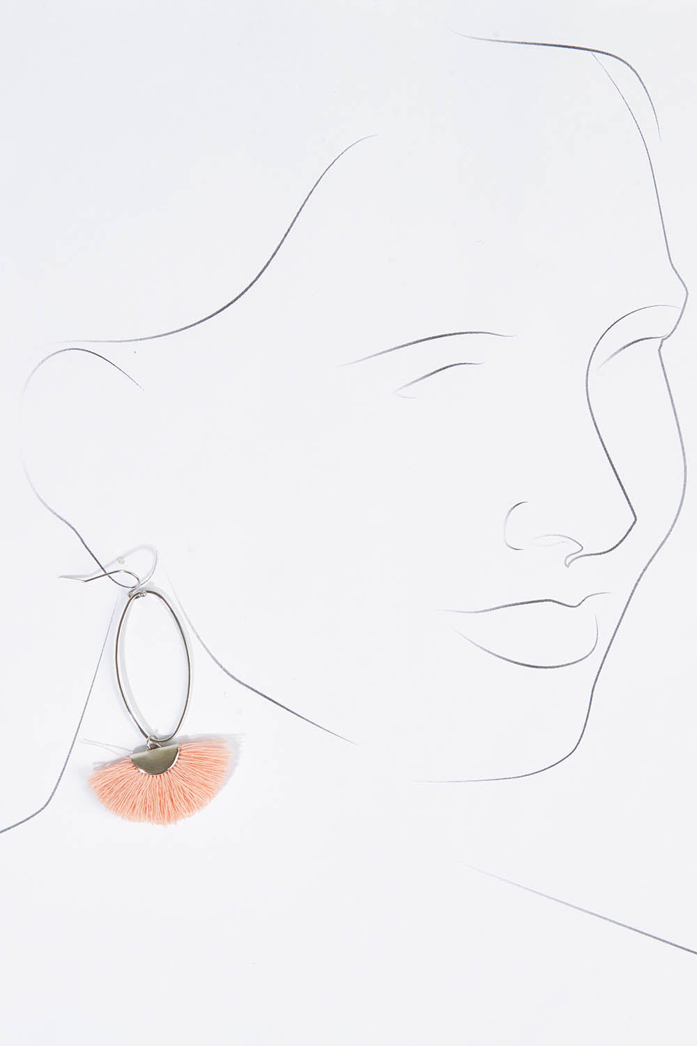 A model wearing size OneSize of the Silver Caprioska Tassel Earrings in colour Peach (Pink), from the front, showing the whole outfit
