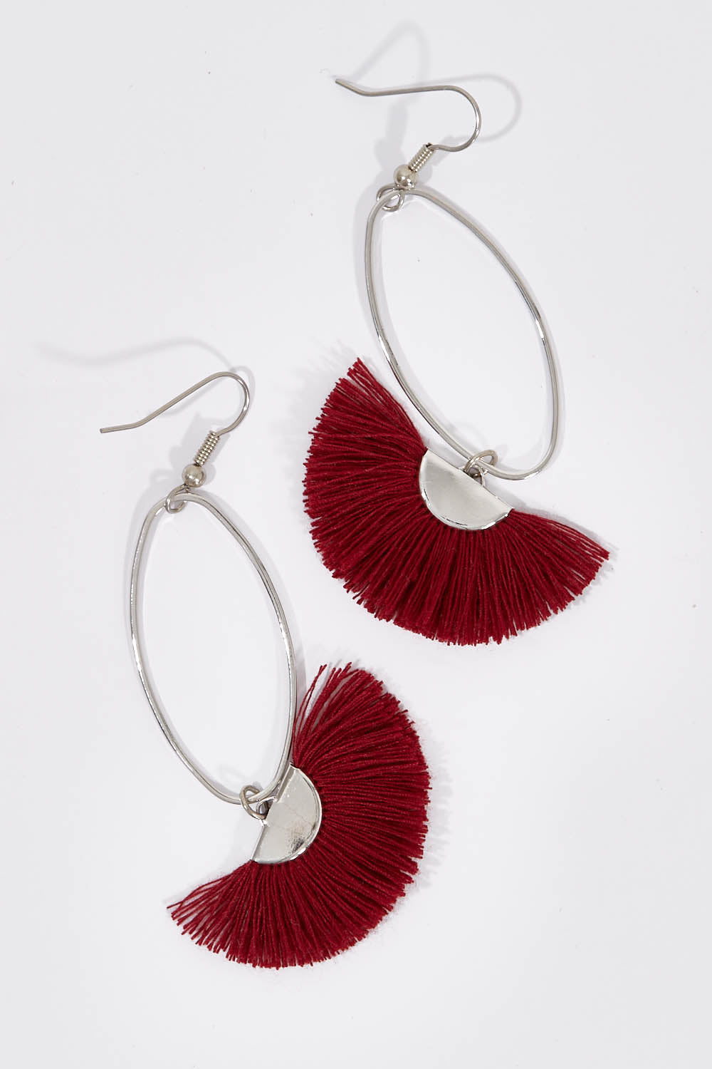 A model wearing size OneSize of the Silver Caprioska Tassel Earrings in colour Shiraz (Red), from the front, showing the whole outfit