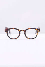 A model wearing size 1 of the Square Reading Glasses in colour Tortoise, from the front, showing the whole outfit