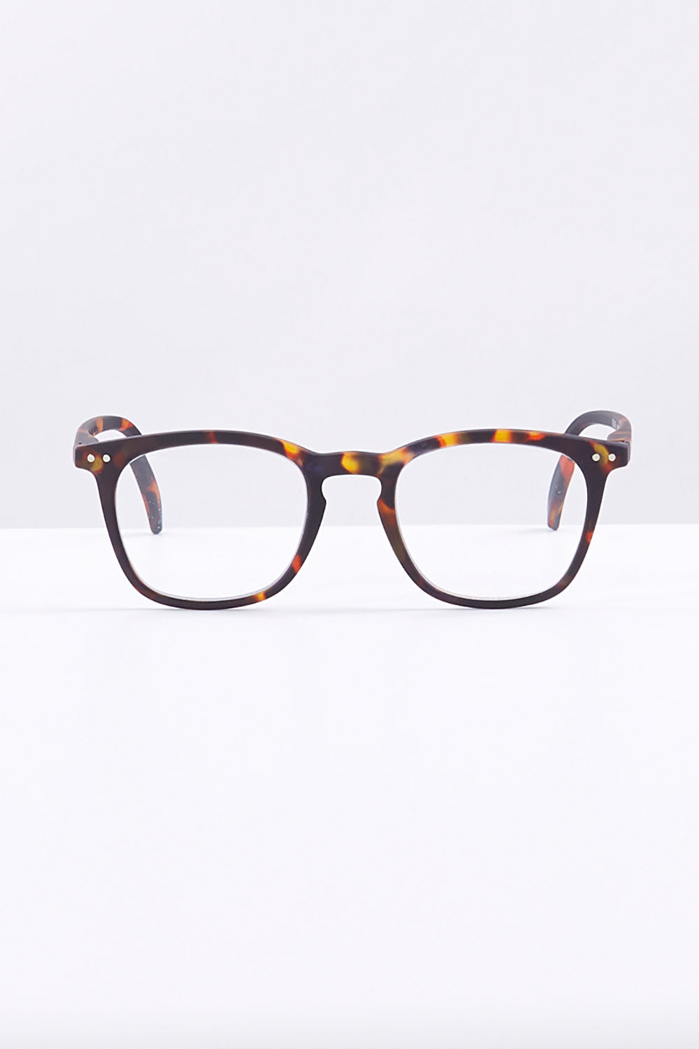 A model wearing size 1 of the E Rectangular Reading Glasses in colour Tortoise, from the front, showing the whole outfit