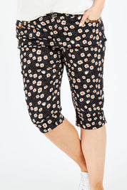 Model Jess wearing size 14 of the Delightful Daisy Capri Pants in colour Blackmulti (Black), from the front, cropped image
