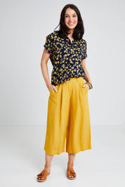 Model Andrea wearing size 10 of the Dela Shirt in colour Navyflora (Blue), from the front, showing the whole outfit