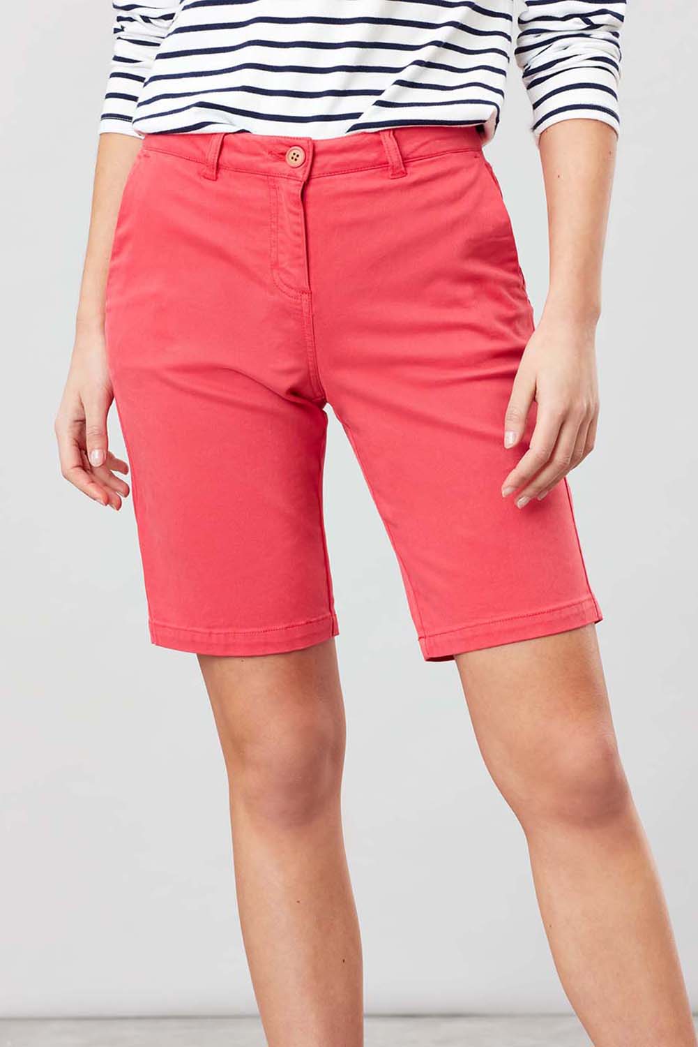 A model wearing the Cruise Longer Length Shorts in colour Poppy (Pink), from the front, cropped image