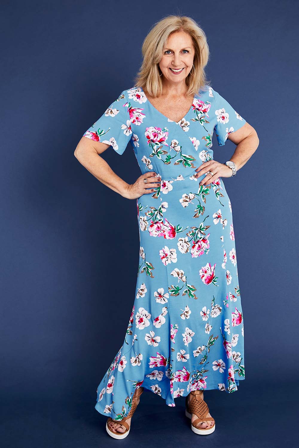Model Sandy wearing size 12 of the Alliana V Neck Dress in colour Blufloral (Blue), from the front, showing the whole outfit