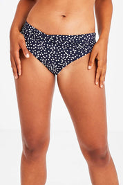 Model Olivia wearing size 10 of the Belle Bikini Bottom in colour Navyspot (Blue), from the front, cropped image