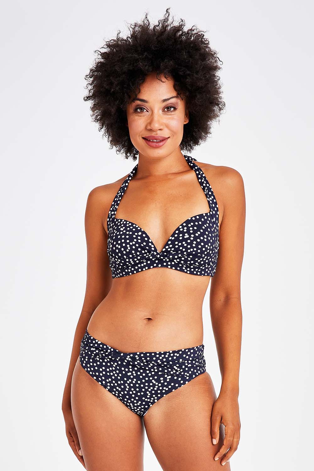 Model Olivia wearing size 10 of the Belle Bikini Bottom in colour Navyspot (Blue), from the front, cropped image