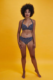 Model Olivia wearing size 10 of the Belle Bikini Bottom in colour Navyspot (Blue), from the front, showing the whole outfit